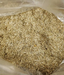Chopped flax bedding filling a clear bag inside an open box.