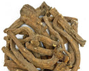 Close-up of dandelion root pieces showing rough brown surfaces, curved shapes and cut ends