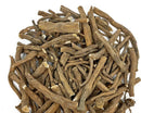 Pile of natural dandelion roots in mixed lengths and thicknesses on a white background.