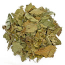  Pile of dried apple leaves and small stems in green and brown shades on a white background.