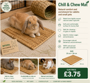 Rabbit relaxing on a natural woven water hyacinth mat inside a comfortable indoor enclosure.