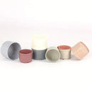 Set of eight pastel stacking cups for rabbit foraging and play; colours may vary