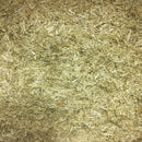 Chopped flax bedding showing a layer of small, pale natural flax pieces.