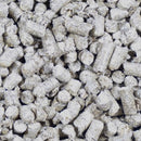 Close-up of short cylindrical straw litter pellets showing their compressed fibrous texture.